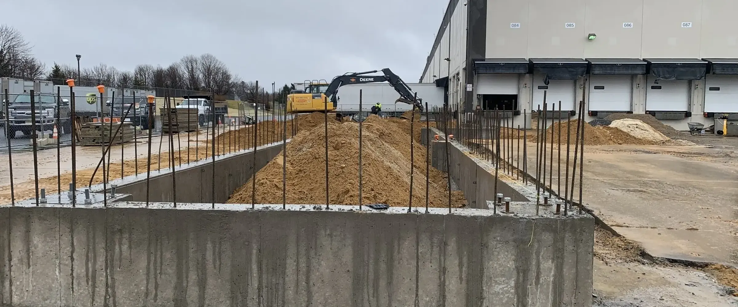 New poured concrete wall beside a warehouse
